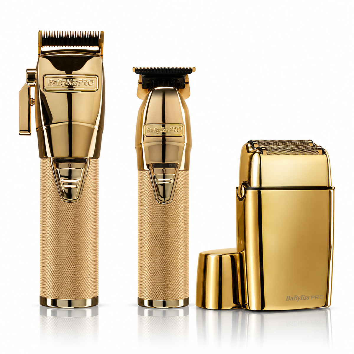 A professional grooming kit featuring a gold clipper, a matching dark gray trimmer, and a gold rotary shaver with its charging case and cap, all on a reflective white background.
