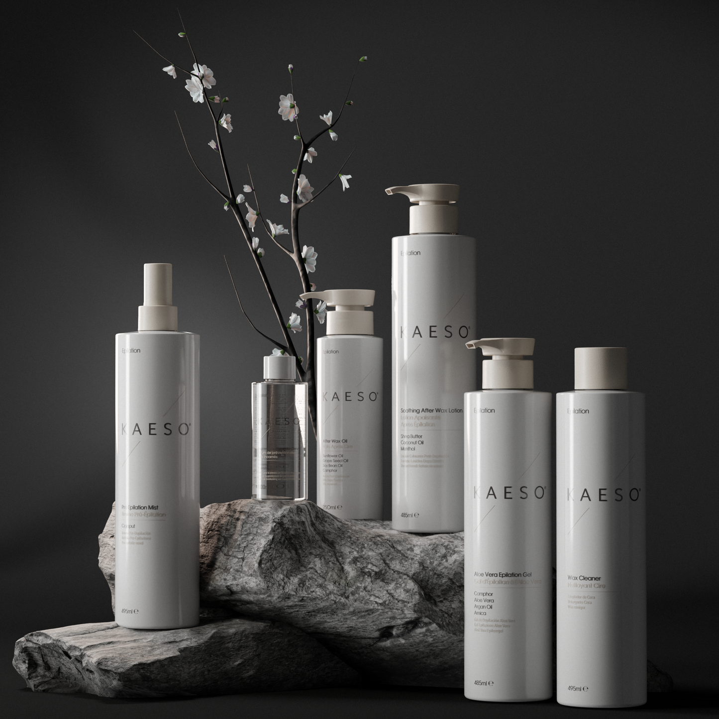 Six Kaeso epliation hair removal products in minimalist white and silver packaging are arranged on a dark stone pedestal with a small flowering branch behind them against a dark studio background.