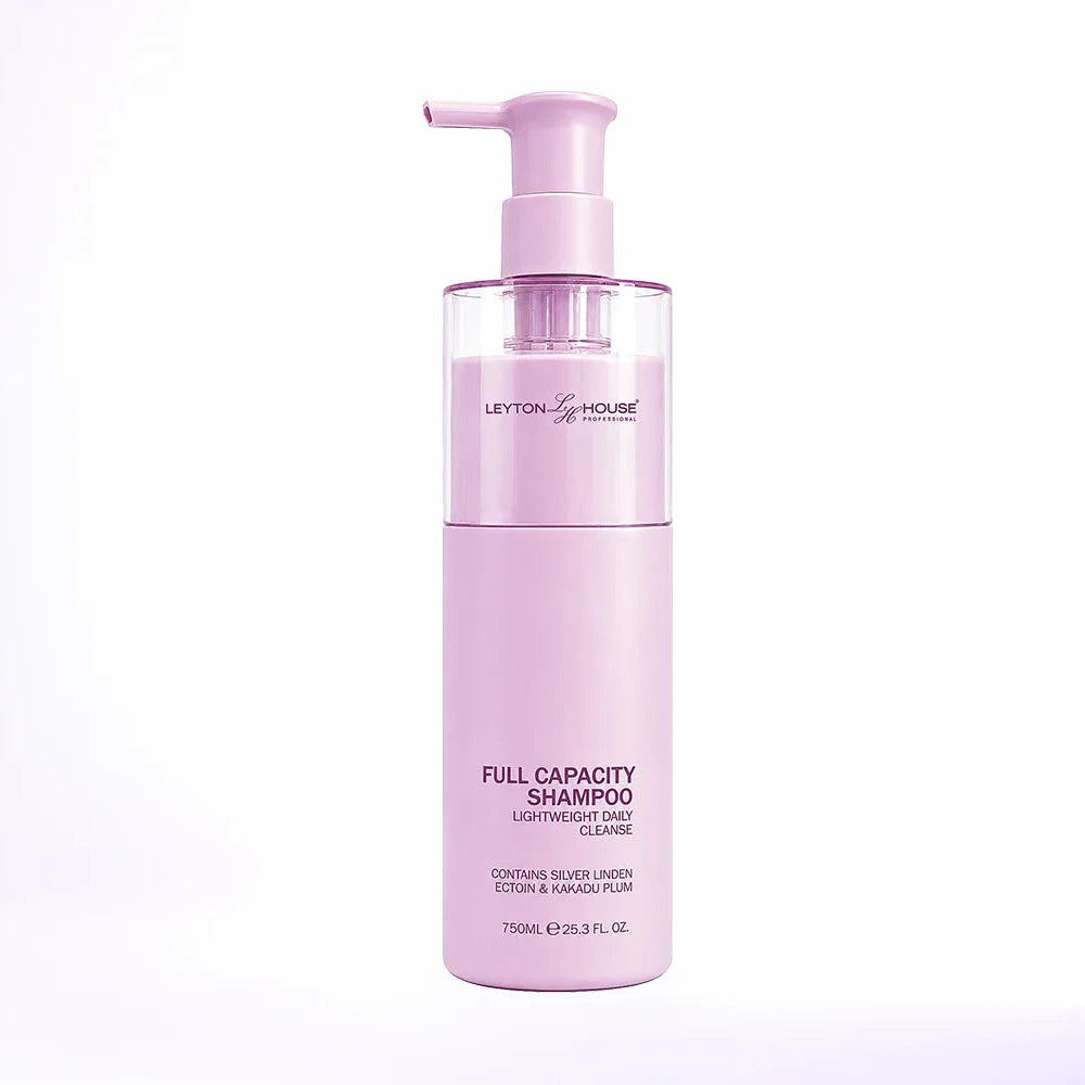 A bottle of Layton's House Full Capacity Shampoo in a soft pastel pink color, featuring a matching pink pump dispenser, set against a clean white background with a subtle lavender tint.