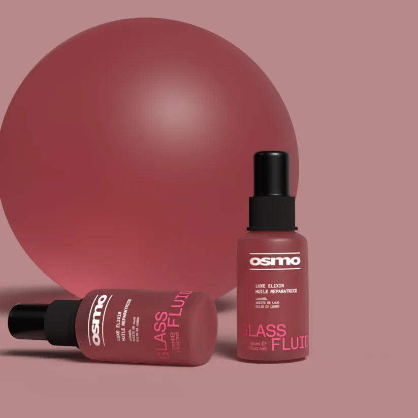 Two Osmo Glass Fluide hair products on a pink background