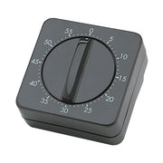 A black manual alarm clock with a analog display and a knob for setting the time.