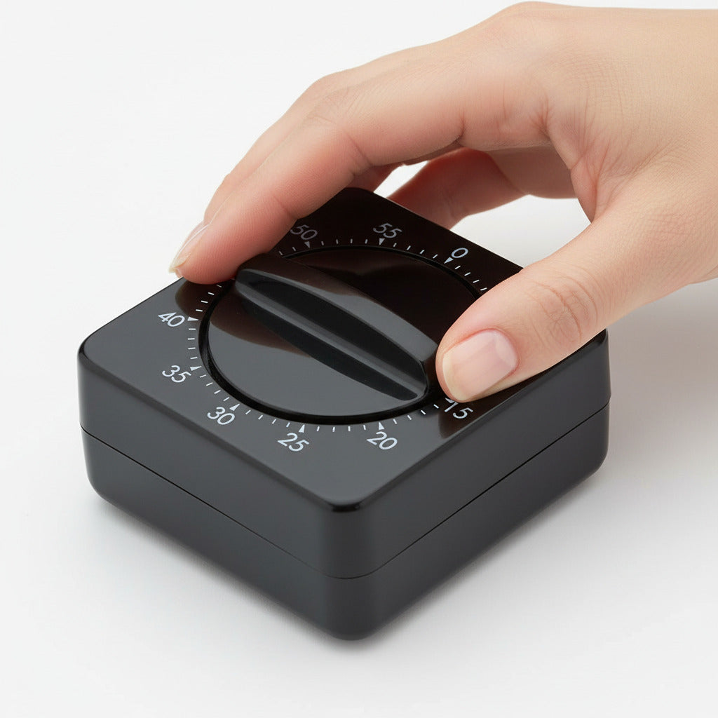 Black kitchen timer with a white background