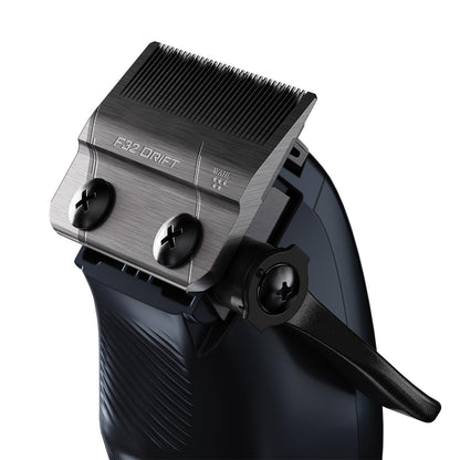 Close-up of a hair clipper head showing the F32 Drift metal cutting plate, adjustment screws, and black lever on a dark body, isolated on a white background.