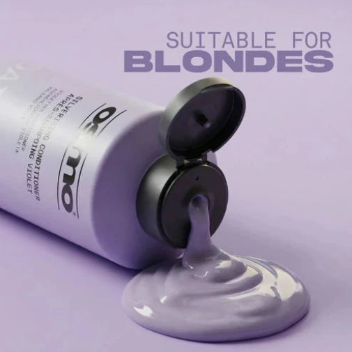 A tube of Osmo Purple Root Protecting Conditioner is shown lying on its side with the cap open, with purple conditioner dripping out onto a matching light purple background. Text in the upper right reads 'SUITABLE FOR BLONDES'.