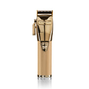 Gold BaBylissPRO professional hair clipper standing upright on white background