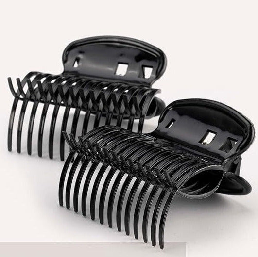 A pair of black plastic hair roller grips designed to hold rollers for creating curls.