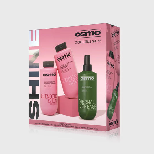 Osmo Incredible Shine haircare set in a pink box, featuring a pink shampoo bottle, a pink conditioner bottle, and a green thermal defense spray bottle, shown on a light gray background.