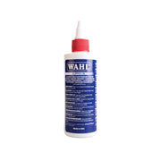 A bottle of Wahl Clipper Oil with a white body and blue label, including product information and branding.