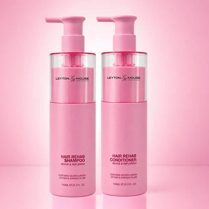 Two pink pump bottles of Leyton House Hair Rehab shampoo and conditioner standing side by side on a pink gradient background.