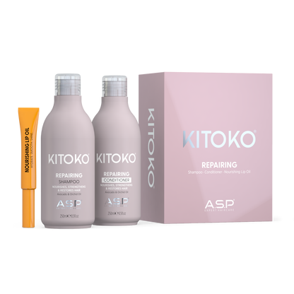 ASP Kitoko Repairing shampoo and conditioner set in pale pink bottles, shown with a pink product box and a small orange nourishing up oil tube on a white background.