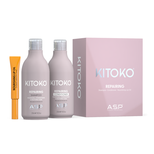 ASP Kitoko Repairing shampoo and conditioner set in pale pink bottles, shown with a pink product box and a small orange nourishing up oil tube on a white background.