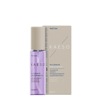 A bottle of KAESO Nail Care Pro Cuticle Oil next to its beige packaging box, featuring a lavender-colored liquid inside a clear bottle with a beige cap.