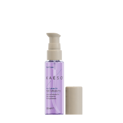 KAESO Nail Care Pro Cuticle Oil in a clear bottle showing light purple liquid, with a beige pump dispenser and a separate beige cap on a white background.