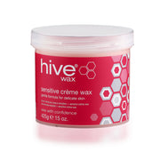 A container of Hive Sensitive Crème Wax, with a predominantly pink label, indicating that it is a gentle formula suitable for delicate skin.