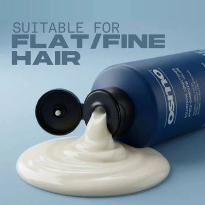 Blue bottle of hair product with white foam on a light blue background, labeled 'Osmo'.