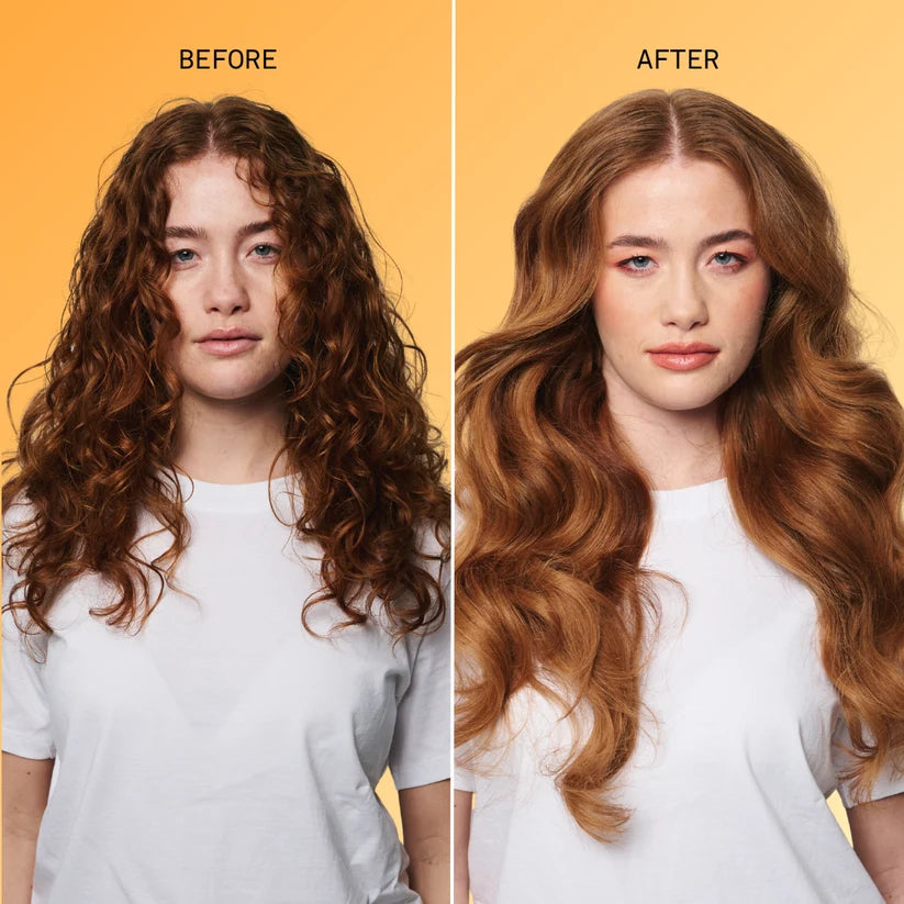 Before-and-after hair transformation showing a woman with curly brown hair on the left and long, wavy auburn-brown hair on the right, set against a solid yellow-orange background.