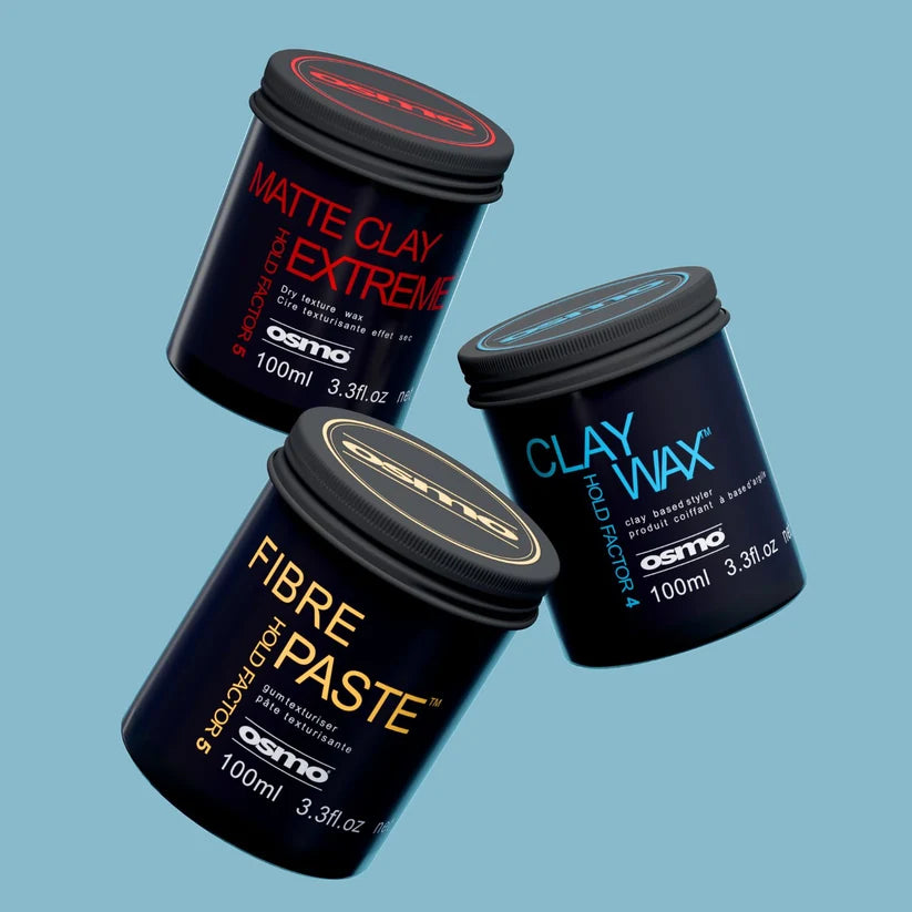 Three Osmo clay products in black plastic jars with black lids, floating on a light blue background: Matte Clay Extreme with red text, Clay Wax with blue text, and Fibre Paste with gold text.