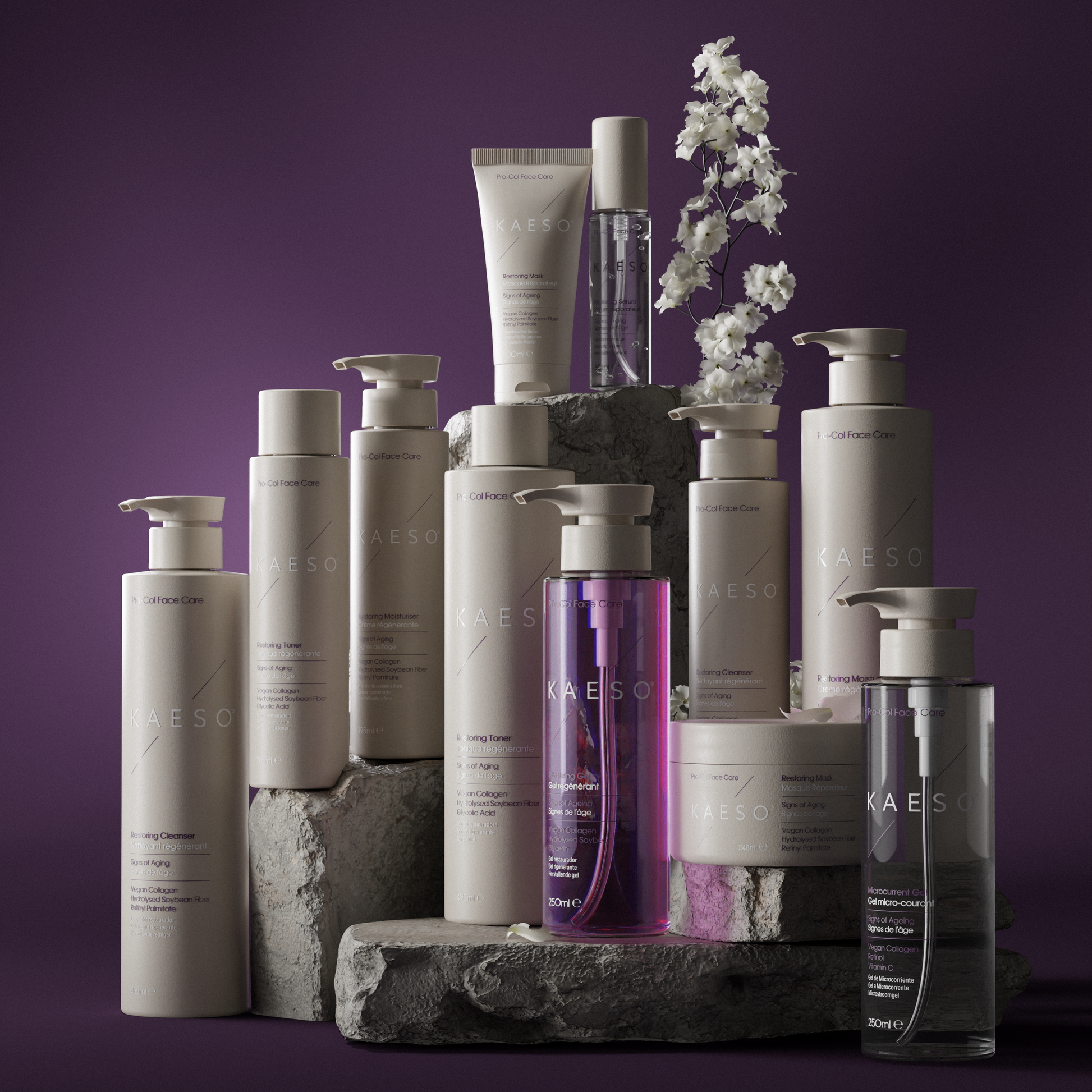 A collection of KAESO skincare and haircare products arranged on stacked stone blocks against a dark purple background. The products are mostly off-white and beige with one prominent purple bottle and one clear bottle with a gray cap.