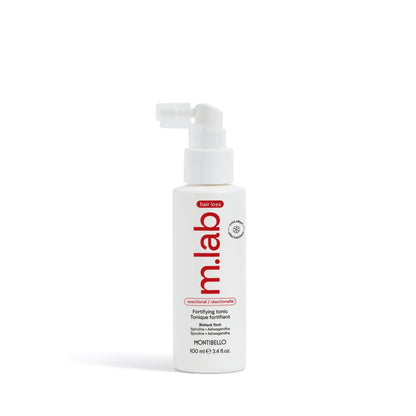 White bottle with red label on a white background