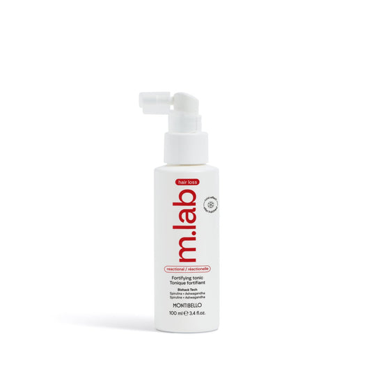 White bottle with red label on a white background