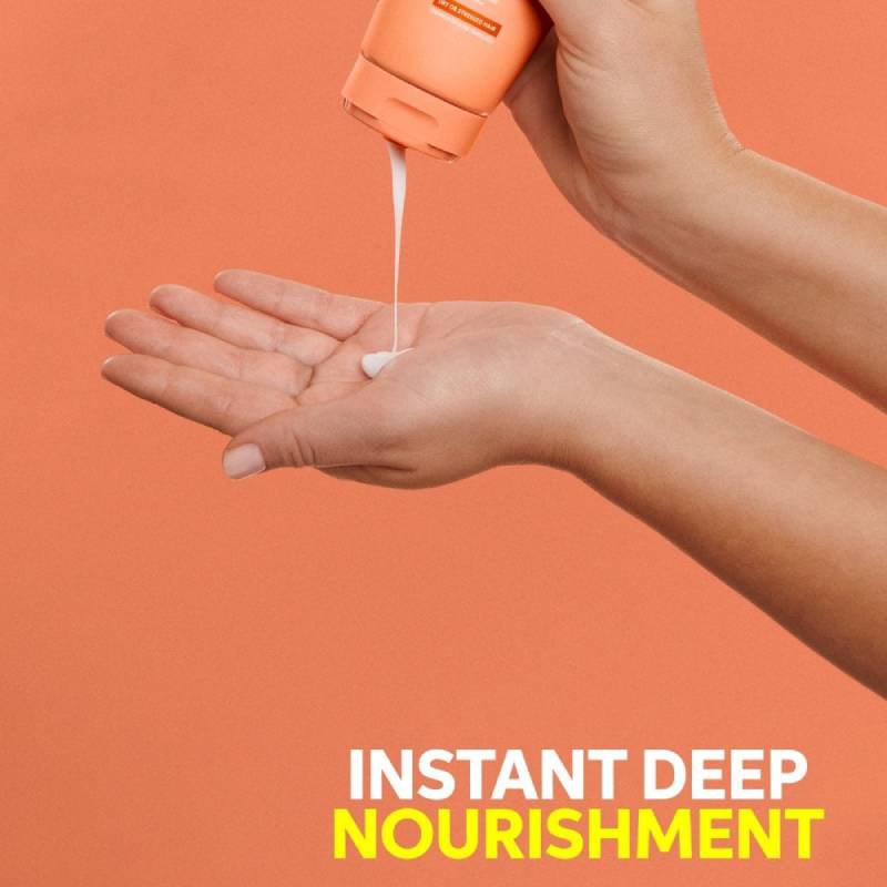 Hand being poured with a product labeled 'Instant Deep Nourishment' against an orange background wella Nutri-Enrich conditioner