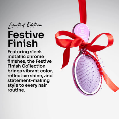 A purple oval hairbrush with metallic chrome accents, tied with a bright red ribbon and bow, on a light gray background with promotional text reading 'Festive Finish' and 'Limited Edition.'.