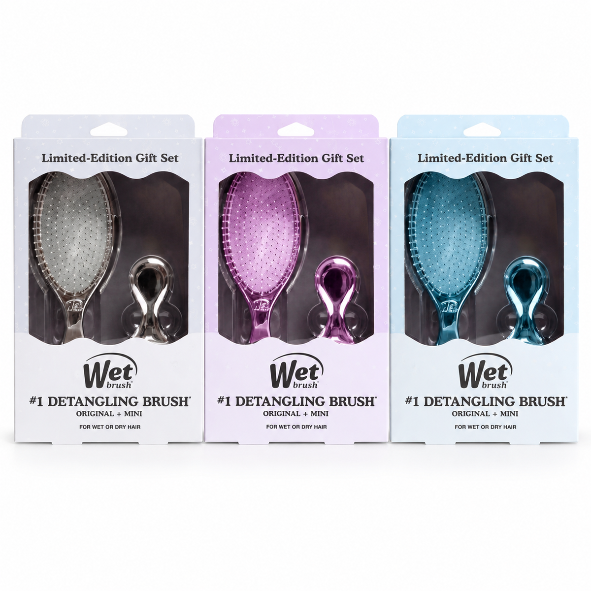Three Wet World detangling brush gift sets in different colors (silver, purple, and blue) in their retail packaging, arranged side-by-side on a white background.