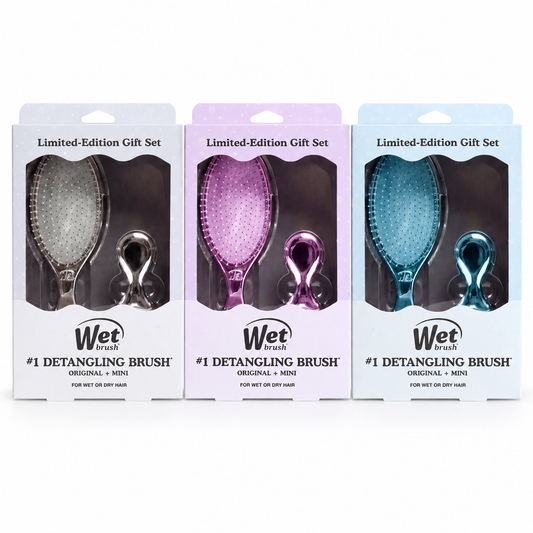 Three Wet World detangling brush gift sets in different colors (silver, purple, and blue) in their retail packaging, arranged side-by-side on a white background.