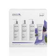A product image featuring a Strictly Professional brand facial kit for dry skin, containing cleanser, toner, moisturizer, and facial mask in pump bottles, packaged in a white box with a purple flower illustration.