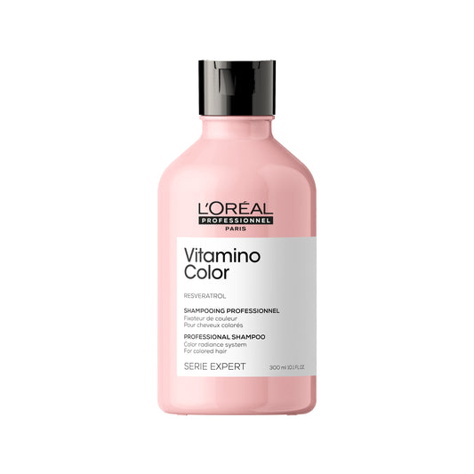 A pink bottle of L'Oréal Serie Expert Vitamino Color Shampoo with black cap and label detailing the product line and brand.