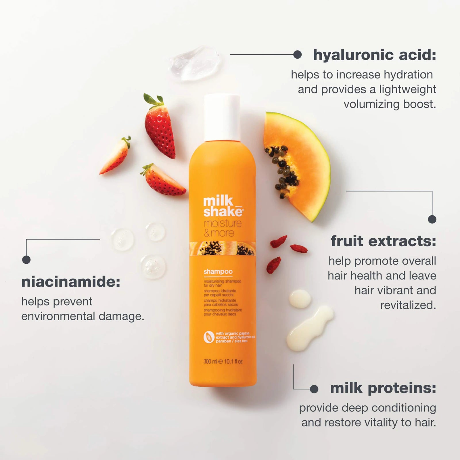 Orange shampoo bottle with fruit extracts on a light gray background