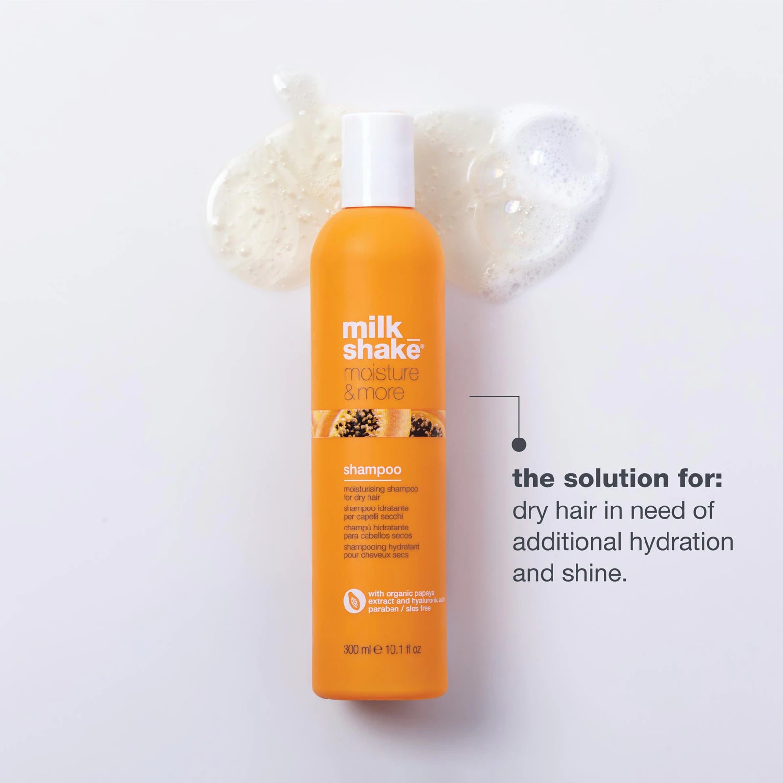 Orange shampoo bottle with 'milk shake' branding on a white background