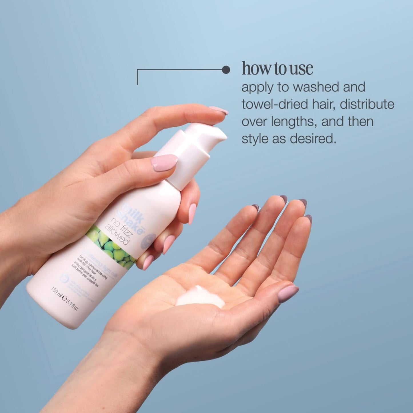 Hand holding a bottle of hair product with a close-up of the palm showing the product, against a light blue background.