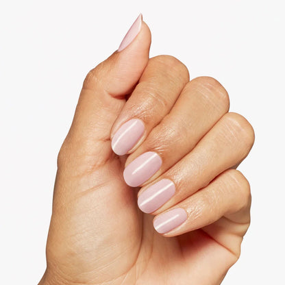 Hand with pink nail polish on a light background