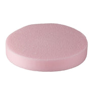 A pink cosmetic sponge designed for facial cleansing or product removal, in a dry state.
