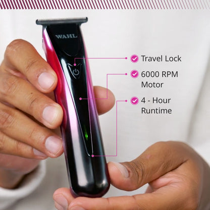 A Wahl electric hair trimmer with a black and metallic pink body, held by two hands. The image includes feature callout text overlays highlighting 'Travel Lock', '6000 RPM Motor', and '4 - Hour Runtime'.