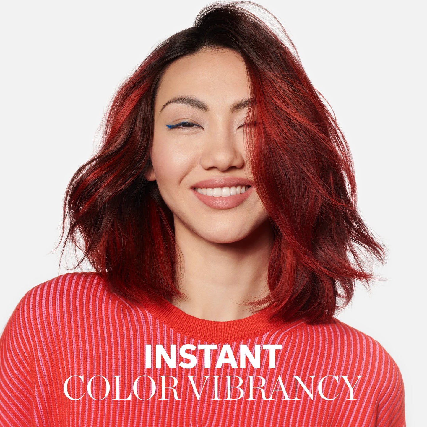 Woman with red hair and a red sweater, with 'Instant Color Vibrancy' text. wella color brilliance
